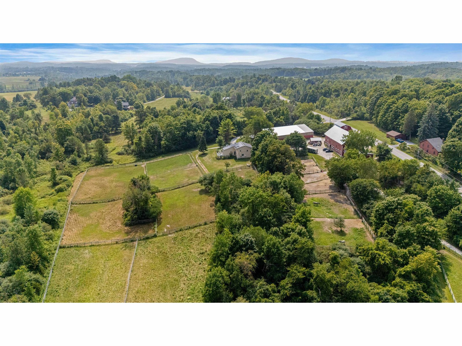 view of paddocks near the barn and pastures
