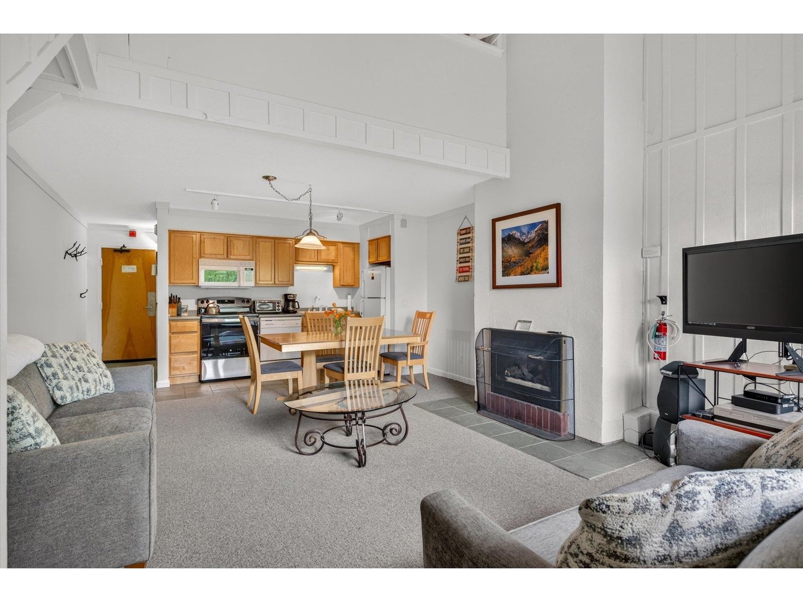Living area is highlighted by a propane fireplace and cathedral ceilings
