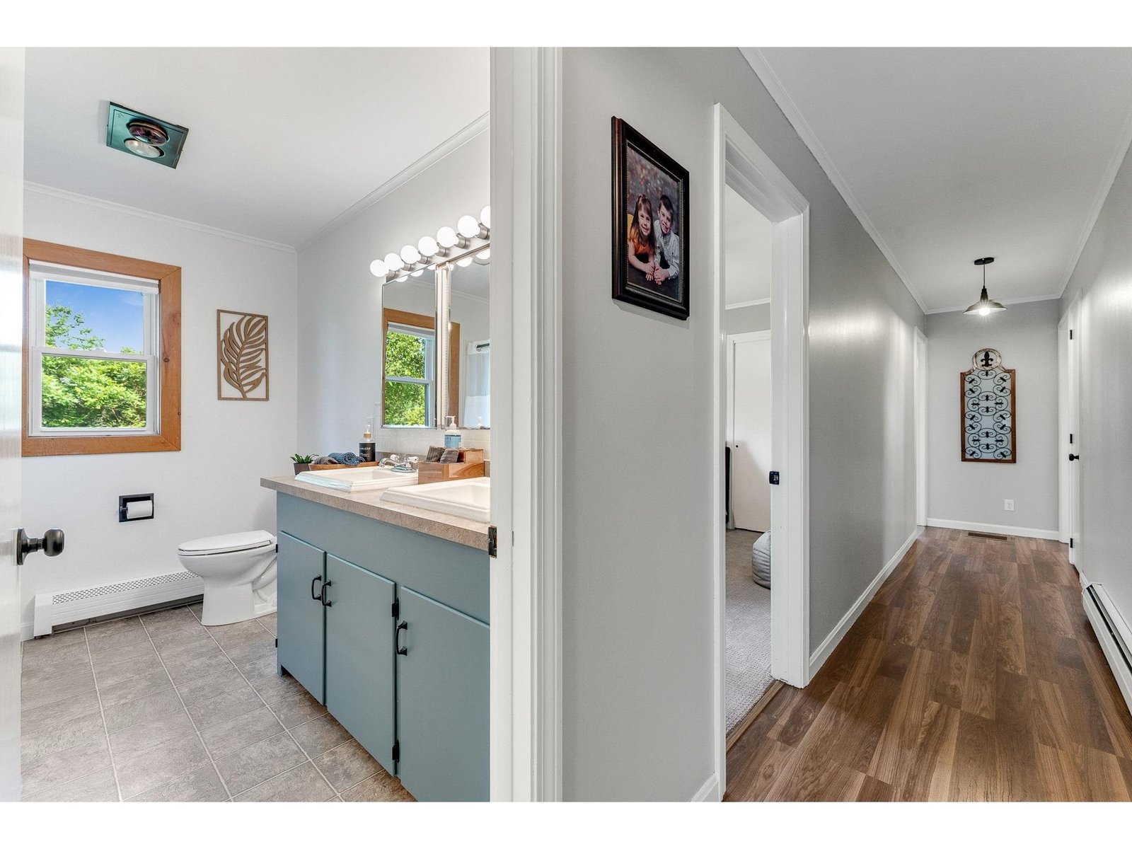 Hallway to 3 bedrooms with new vinyl flooring