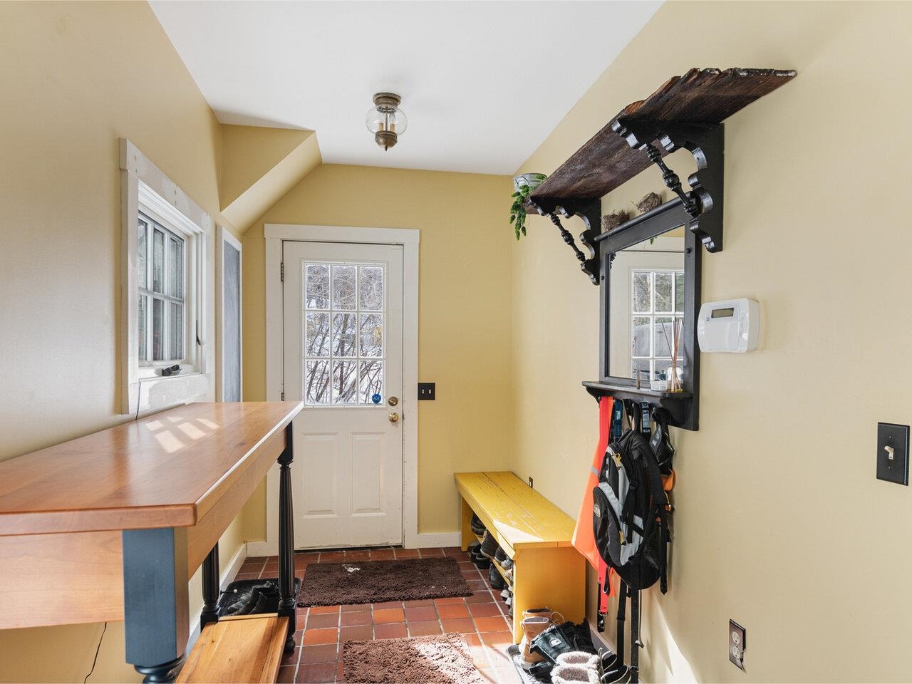 Tiled mudroom off driveway