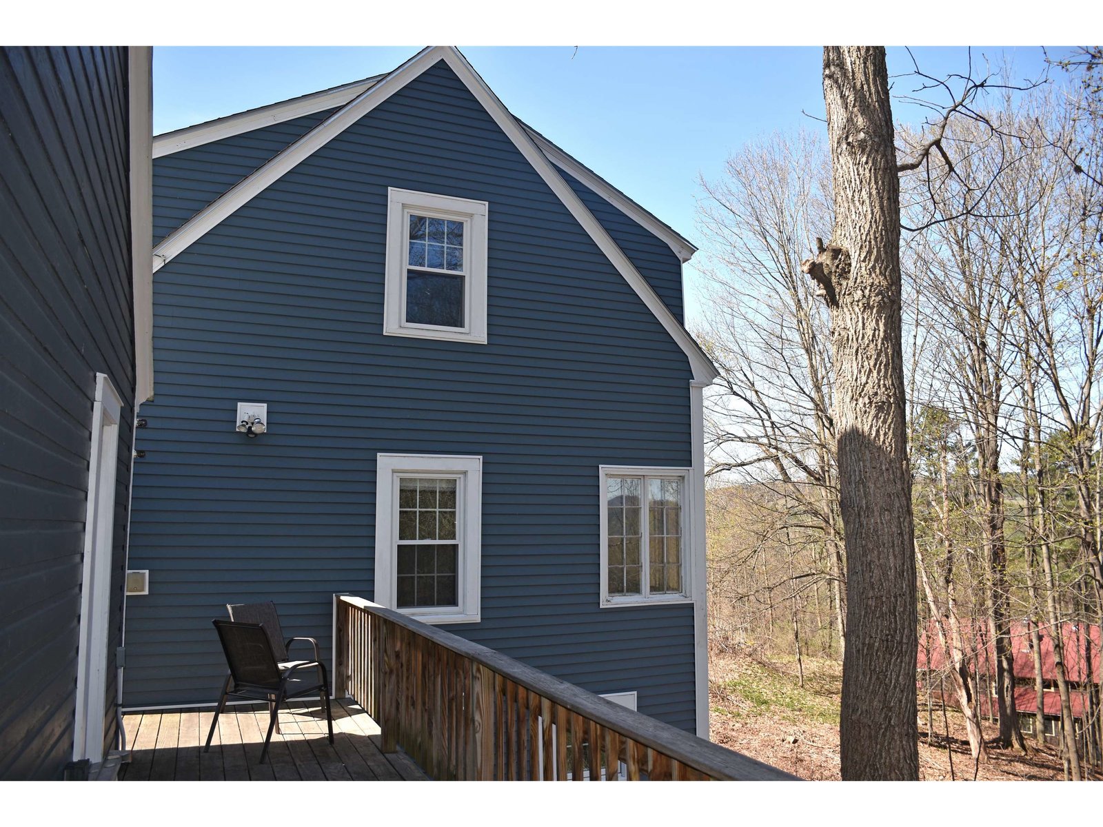 Deck behind garage with Village views