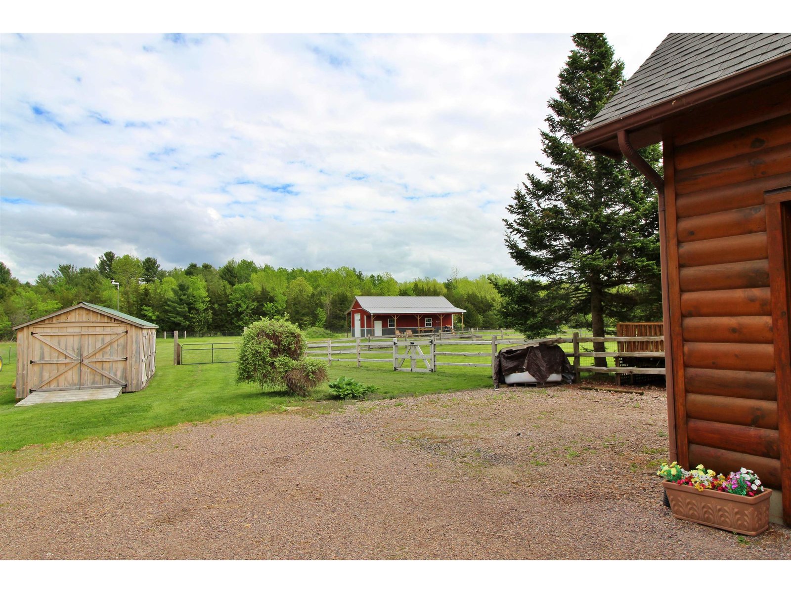 Looking to the back yard and outbuildings