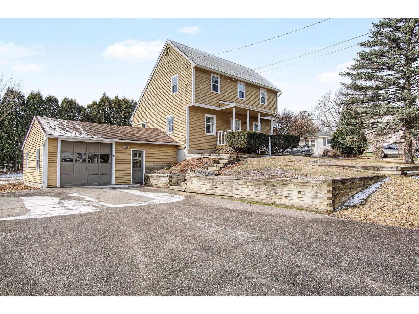 Large Paved Driveway with Attached 1-Car Garage