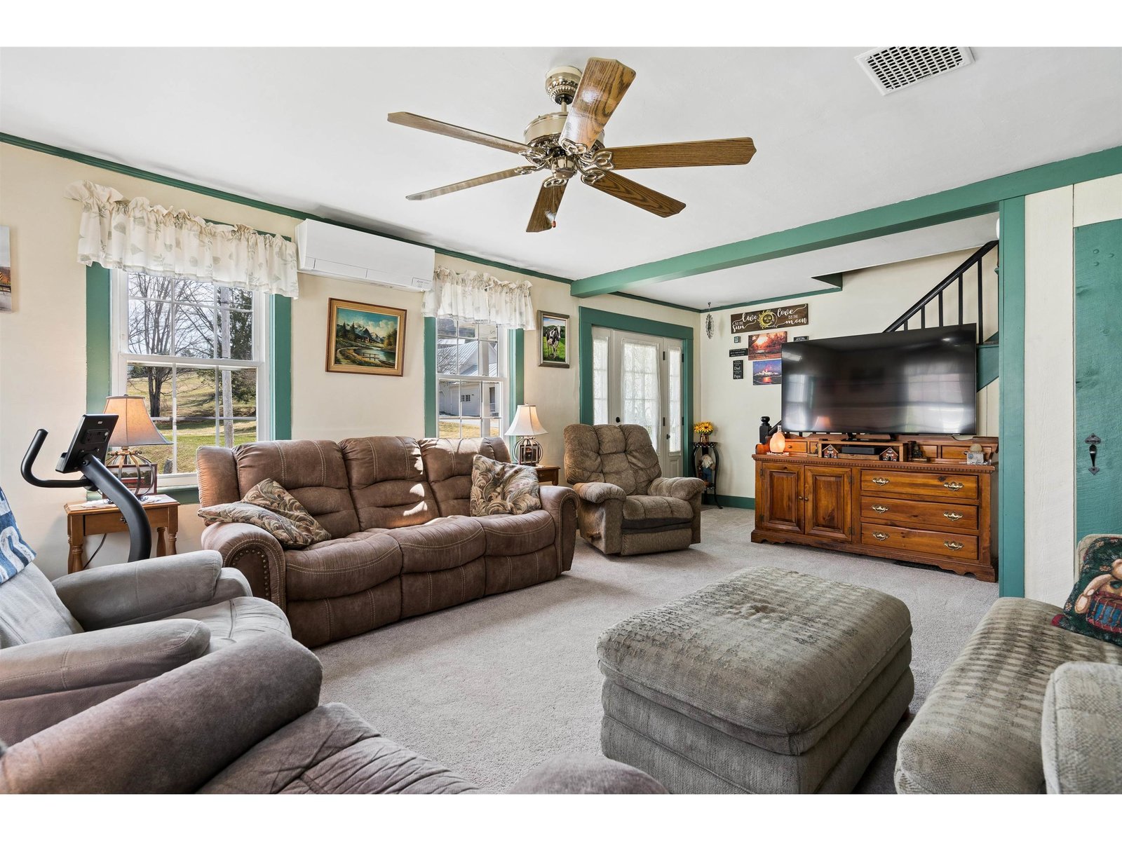 Living room on first floor with view of front porch doorway