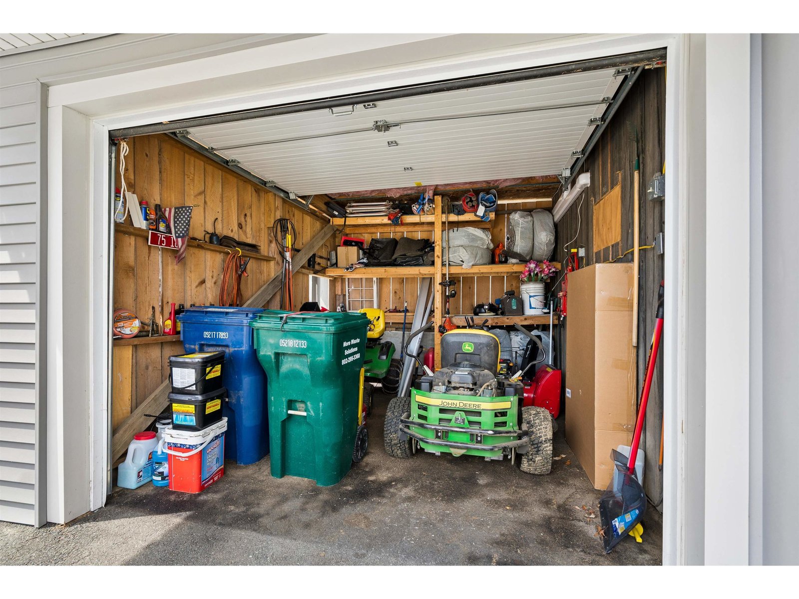 Exterior accessed storage area with garage door