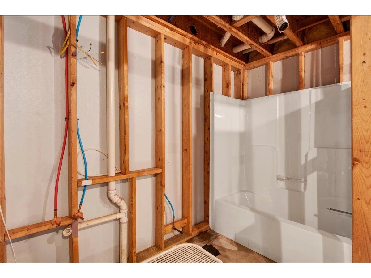 Unfinished Basement with Tub, Rough-In Plumbing, and Framing