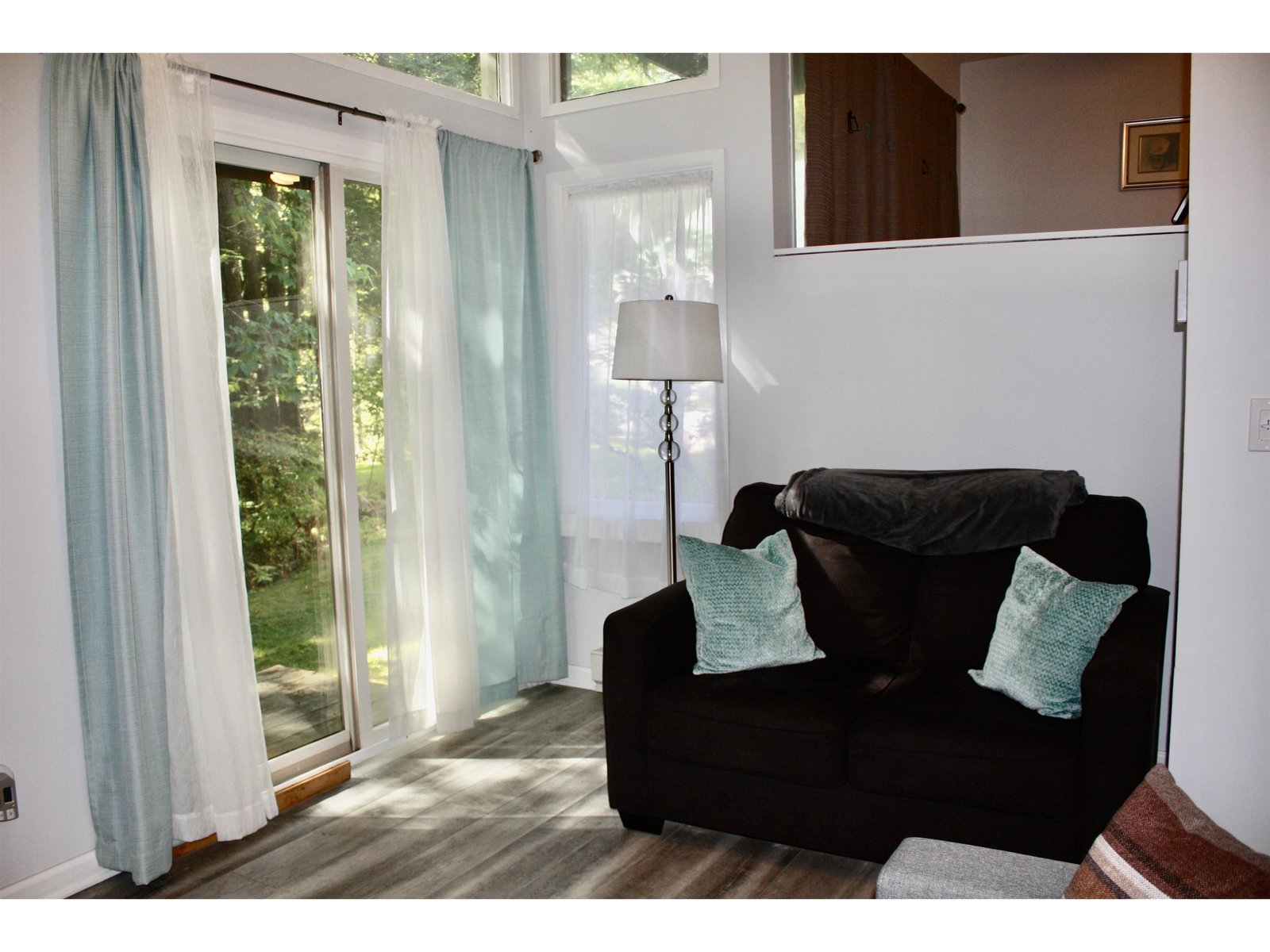 Living area with sliding doors leading outback of building.