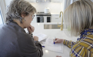 Negotiating and Closing the Sale of Your Home 4 Carly Fleming goes over contract with a client