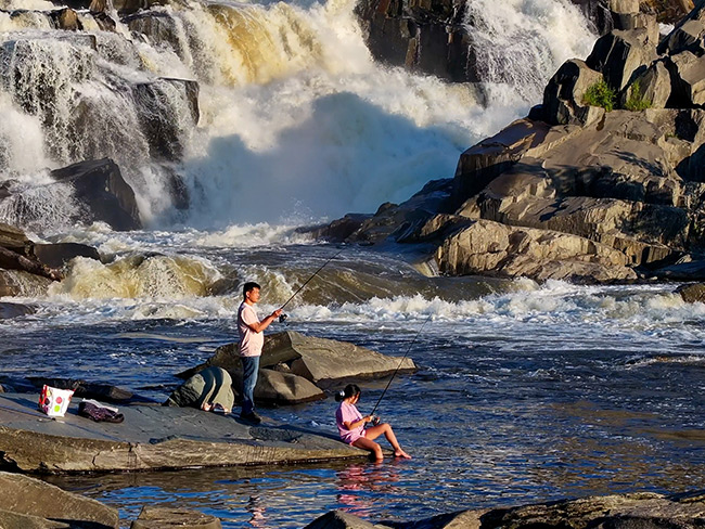 Fishing by the dam in